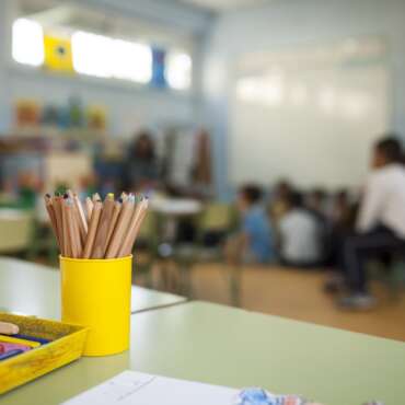 pens and paints on table in a primary school class
