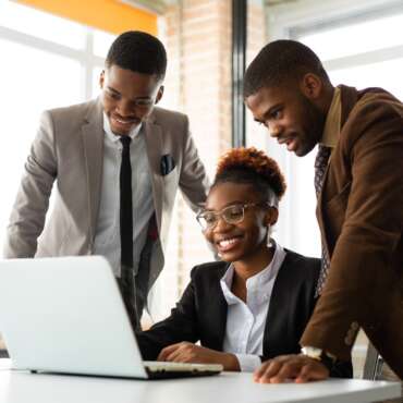 team of young african people in office at table with laptop